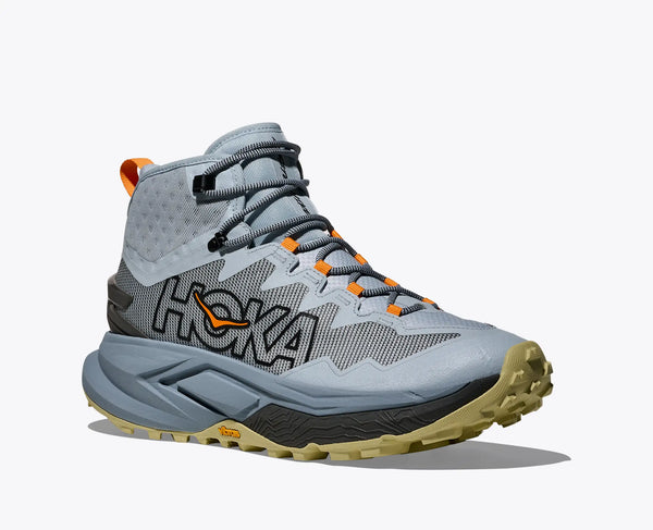 Gray hiking boot with orange accents on a white background