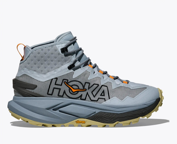 Gray and light blue Hoka hiking boot with a Vibram outsole on a white background