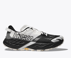 Black and white running shoe with Hoka branding on a white background