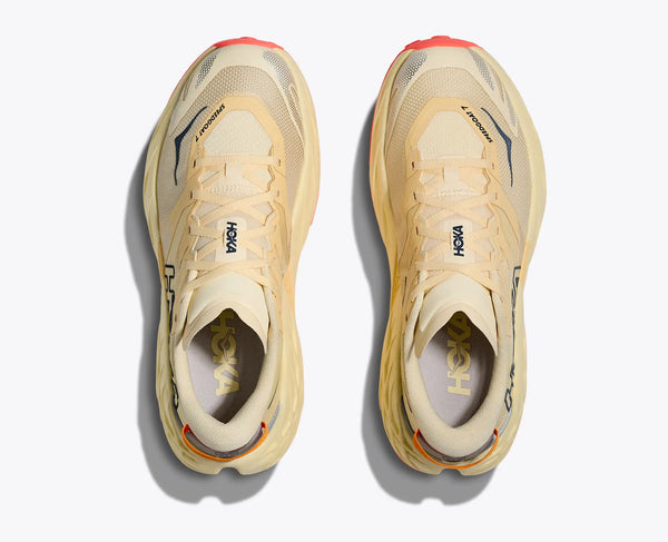 A top down look at a pair of Women's Speedgoat 7 trail shoes that have a butter colored upper.