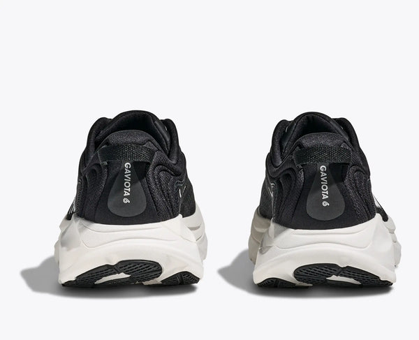 Black and white sneakers with 'Gazelle' branding on a white background