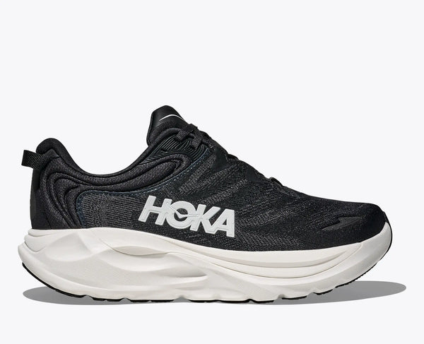 Black running shoe with white sole on a light gray background