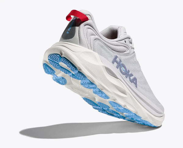 White running shoe with blue sole and red tag on a white background