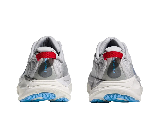 Pair of gray sneakers with red interior and blue sole on a white background