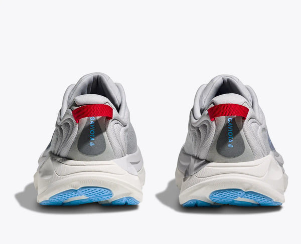 Pair of gray sneakers with red interior and blue sole on a white background