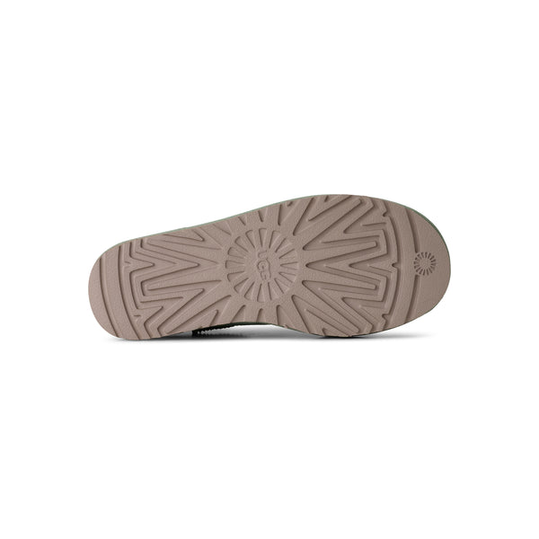 Light green ugg slipper on a white background