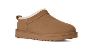 Brown Ugg slipper with white lining on a transparent background.