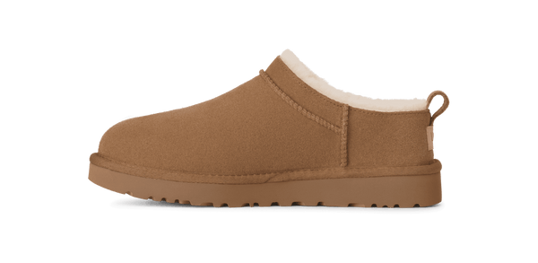 Brown slip-on shoe with white lining on a green background