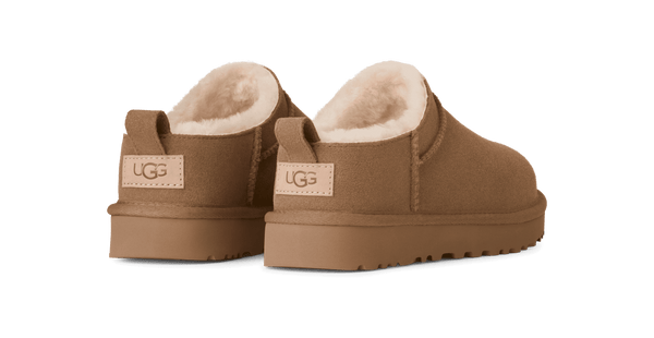 Pair of brown UGG slippers on a transparent background