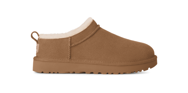 Brown slip-on shoe with white lining on a green background