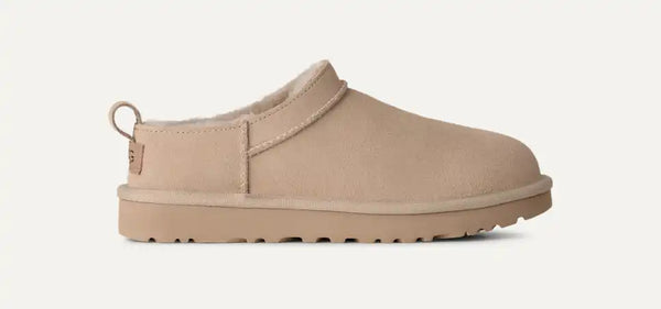 Very light tan Ugg slipper on a white background