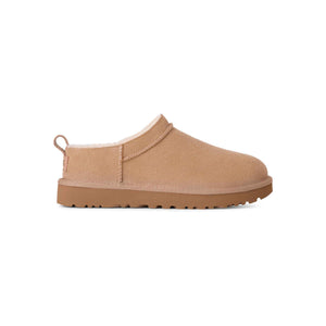 Tan slip-on shoe on a white background