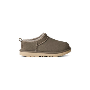 Green kids slipper on a white background