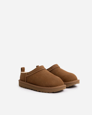 Kids tan slippers on a white background