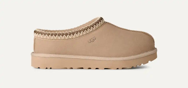 Light tan ugg slipper on a white background