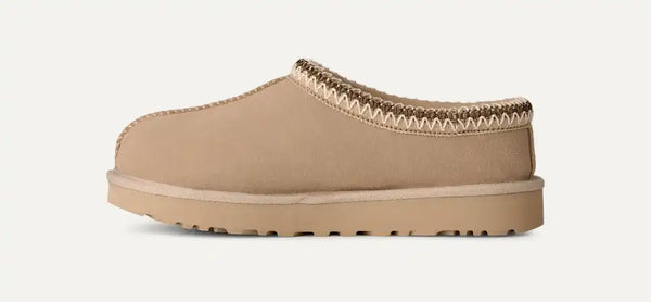 Light tan ugg slipper on a white background