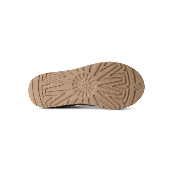 Light tan ugg slipper on a white background