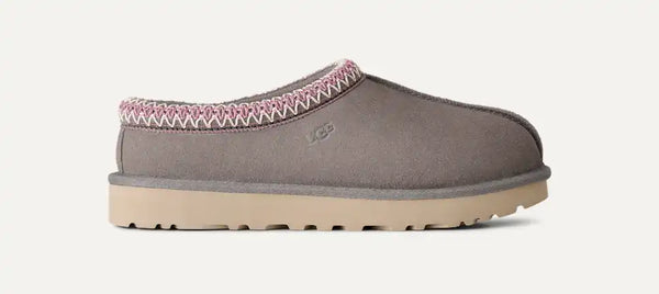 Grey, pink, and tan slipper on a white background