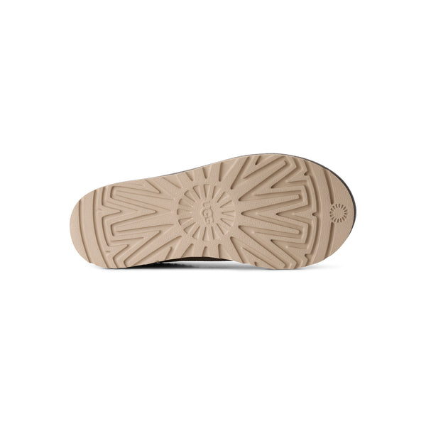 Grey, pink, and tan slipper on a white background