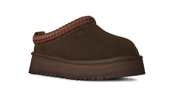 Brown slip-on shoe with a platform sole on a white background
