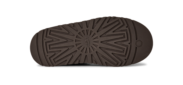 Brown slip-on shoe with a platform sole on a white background