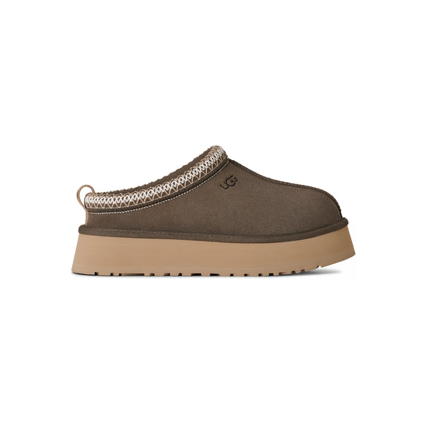 Deep green ugg slipper on a white background