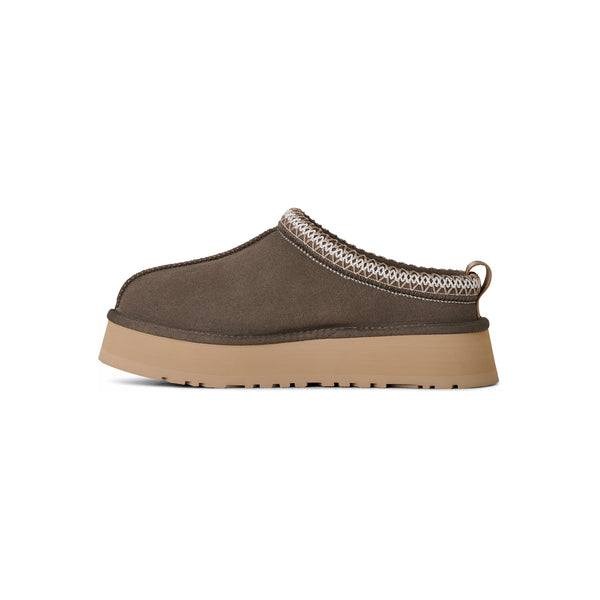 Deep green ugg slipper on a white background