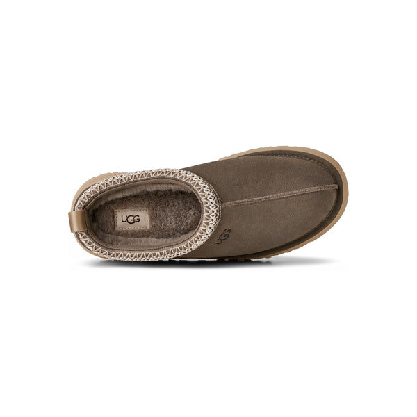 Deep green ugg slipper on a white background