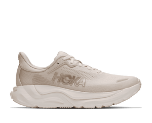 Cream colored running shoe on a white background