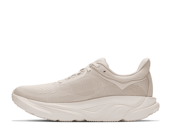 Cream colored running shoe on a white background