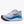 White running shoe with blue and red sole on a white background