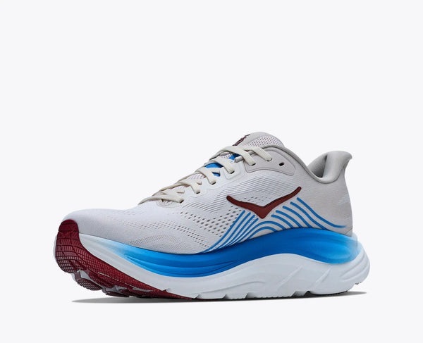 White running shoe with blue and red sole on a white background