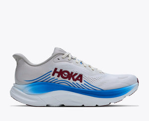 White running shoe with blue sole and Hoka branding on a white background