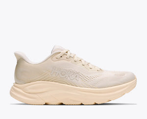 Beige running shoe with 'Hoka' branding on a white background