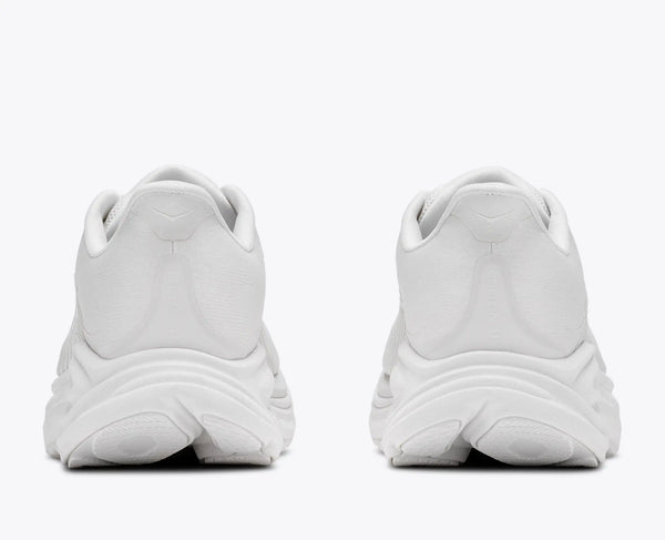White athletic shoes shown from the back on a white background