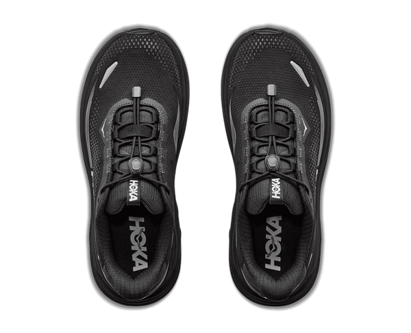 A black running shoe with a thick black sole and silver wavy stripe accents on the side,