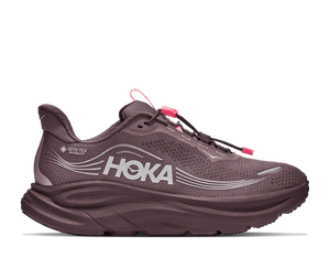 A HOKA running shoe in a muted plum-purple color with bright pink laces and pull tabs