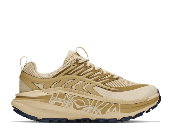 Tan trail running shoe on a white background