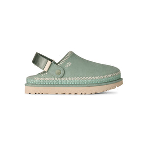 Light green and tan slingback clog on a white background
