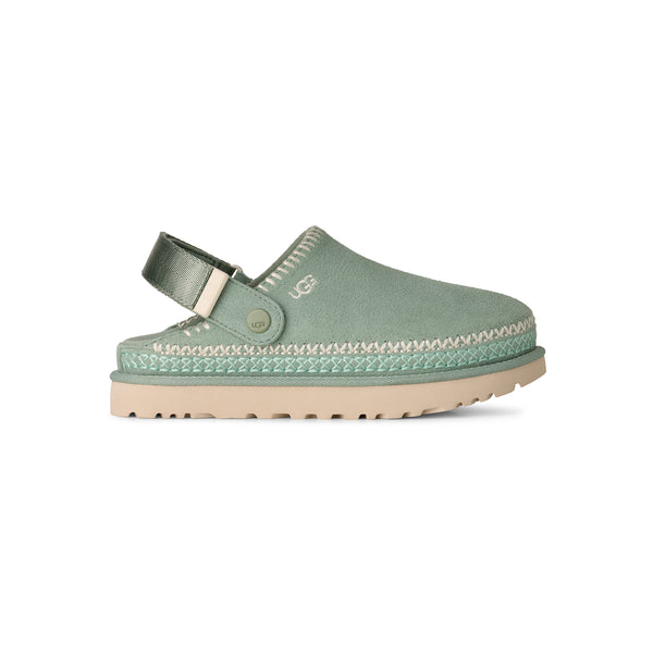 Light green and tan slingback clog on a white background