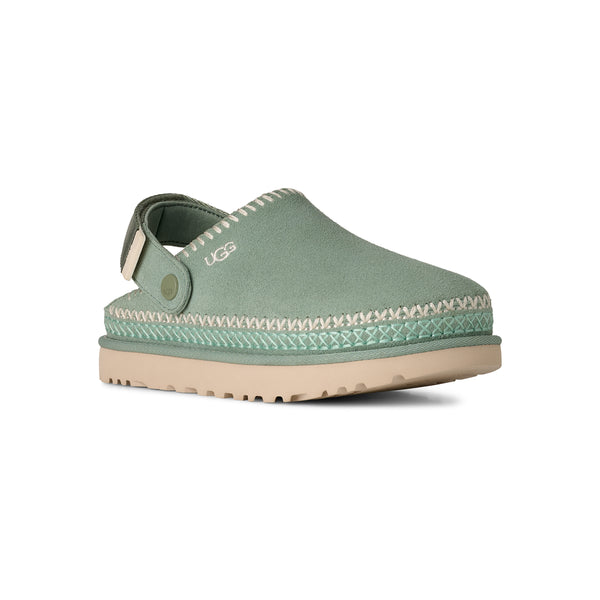 Light green and tan slingback clog on a white background