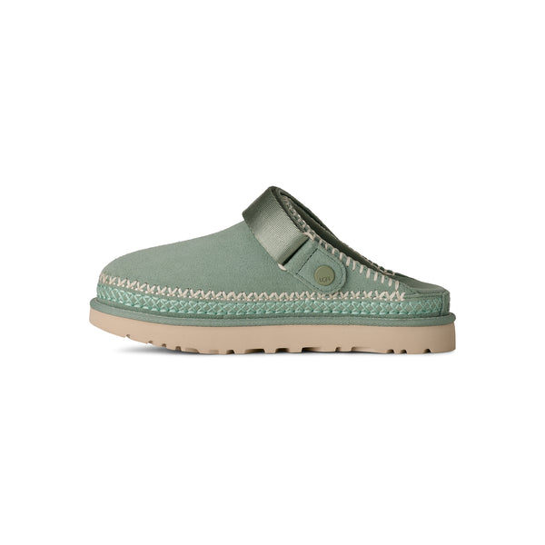 Light green and tan slingback clog on a white background