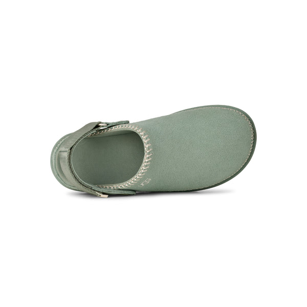 Light green and tan slingback clog on a white background