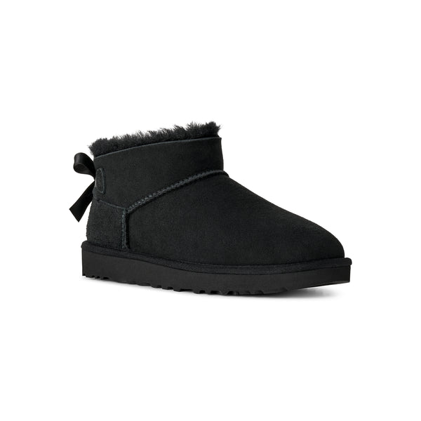 Black ankle length slipper boot with bow on the back  