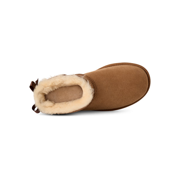 Tan ankle length slipper boot with a bow on the back