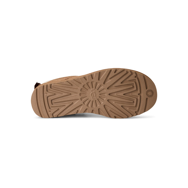 Tan ankle length slipper boot with a bow on the back