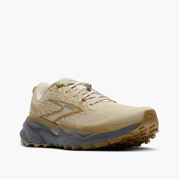 Beige running shoe with visible 'Brooks' logo on a white background