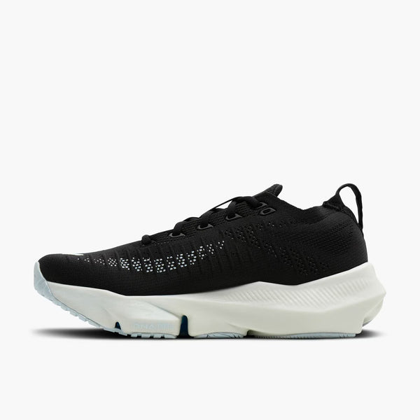 A black knit athletic sneaker with a thick, chunky white midsole and a light blue outsole, shown from a side profile view against a plain white background.