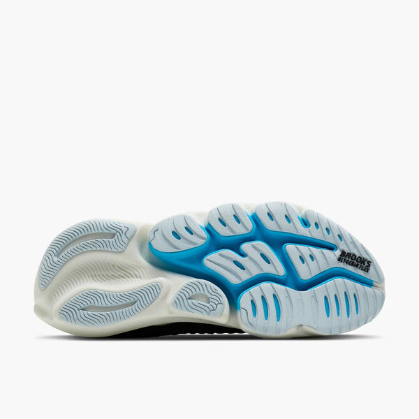 The bottom sole of a running shoe, featuring a white and light blue cushioned design with a blue 'RACING SHIRTS' logo printed on the heel.