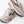 Pair of white and pink running shoes with 'Brooks' branding on a light background